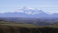 Tourists standing on a mountain top and looking on snow covered peaks. Creative. Picturesque valley in autumn, concept Royalty Free Stock Photo