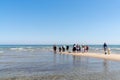 Tourists standing at the northern tip of Denmark where the Baltic Sea and North Sea meet at Skagen Reef Royalty Free Stock Photo