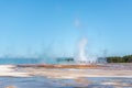 Tourists standing in the steam of Grand Prismatic hot spring