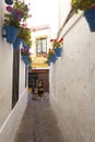 Tourists standing in the Street of Flowers in Cordoba, Spain