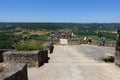 Tourists standing on a viewing platform overlooking the Dordogne from the town of Domme in France