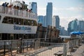 Tourists on Statue City Cruise boat New York City skyline background