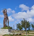 Tourists and the statue of two lovers hugging each other at Lover`s Point at Guam, USA