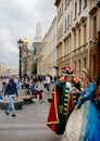 Tourists and street actors on the embankment of the Griboyedov Canal.