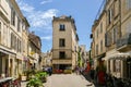 Tourists on street of the historical centre of Arles, an ancient Roman city and commune on the south of France in Royalty Free Stock Photo