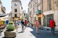 Tourists on street and view of Arenes d`Arles