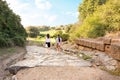 Tourists stroll on the ancient pavement of Vulci, the ancient Etruscan city Italy