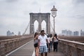 Tourists stroll the famous Brooklyn bridge in New York, USA Royalty Free Stock Photo