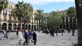 Tourists stroll in the Placa Reial in Spanish Plaza Real, which means `Royal Plaza` is a square in the Barri Gotic.