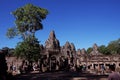 Tourists stroll and take pictures near the Bayon temple. Tourists see the sights of south