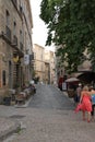 Tourists strolling in the central square of the french city of Pezenas, France