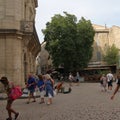 Tourists strolling in the central square of the french city of Pezenas, France