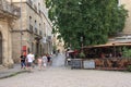 Tourists strolling in the central square of the french city of Pezenas, France