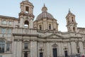 Tourists are strolling at the sunset in a Piazza Navona in city of Rome, Italy