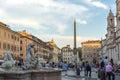 Tourists are strolling at the sunset in a Piazza Navona in city of Rome, Italy