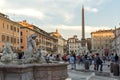 Tourists are strolling at the sunset in a Piazza Navona in city of Rome, Italy
