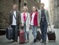 Tourists with suitcases and camera walk along the historic streets of European city Royalty Free Stock Photo