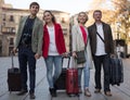 tourists with suitcases and camera walk along the historic streets of European city Royalty Free Stock Photo