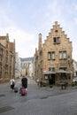 Tourists with suitcases in centre of medieval bruges in belgium