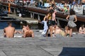 Tourists and sun bathers on Ofella plads in Copenhagen canal