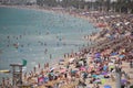 Tourist sunbathe or bath on the sea in crowded El Arenal beach in Mallorca Royalty Free Stock Photo