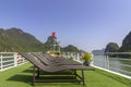 Tourists sunbathing in boat rooftop at Ha Long Bay Descending Dragon Bay popular tourist destination in Asia. Royalty Free Stock Photo