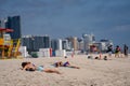 Tourists sunbathing on Miami Beach social distancing during covid 19 pandemic