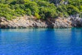 Tourists swim by enjoying deep blue waters in Korsan Cove of Adrasan.