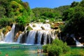 Tourists swim in the lake near picturesque cascade waterfall in summer. The big beautiful Croatian waterfalls, rivers Royalty Free Stock Photo