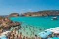 Tourists swimming at Blue Lagoon, Comino, Malta