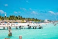 Tourists swimming or holidaying at beach, yachts or sailboats in the background Royalty Free Stock Photo