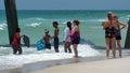 Tourists swimming by the pier