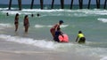 Tourists swimming by a pier