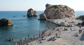 Tourists swimming and relaxing at famous Rock of Aphrodite beach