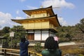 Tourists take a photo famous Kinkakuji Temple The Golden Pavilion in Kyoto, Japan