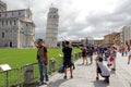 Tourists take a photo of Themselves before the leaning tower of Pisa