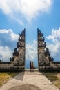 Tourists take photos at the gates of Pura Lempuyang Luhur Temple in Bali, Indonesia