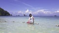 Portrait Asian woman Standing in the sea of clear skies at krabi in Thailand Royalty Free Stock Photo