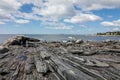 Tourists take photos of a lobster boat and shoreline on a sunny summer morning