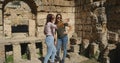 Tourists take photos near ancient temple roman architecture in open air museum