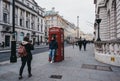 Tourists take photos by red phone booth in Regent Street St. James, London, UK Royalty Free Stock Photo