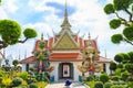 Tourists take pictures an ancient Giant statues in Wat Arun, Temple of Dawn Thailand