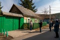 Tourists take pictures at the house-museum of the writer V.P. Astafyev with a memorial plaque at the entrance in the spring