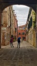 Tourists take pictures of traditional Venetian courtyard