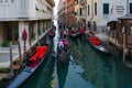 Tourists take walk on gondolas along canals of Venice, Italy