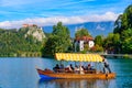 Tourists taking boat on Lake Bled in Slovenia