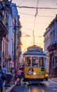Tourists taking the iconic yellow tram of lisbon at sunset