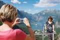 Tourists taking photo against Geirangerfjord