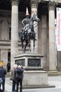 Tourists taking photo of the Duke of Wellington Statur in Royal Exchange Square outside the Gallery of Modern Art
