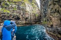 Tourists taking photos to the spectacular Vestmanna cliffs in Faroe Islands Royalty Free Stock Photo